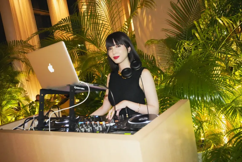 Samantha performing a DJ set at an event.